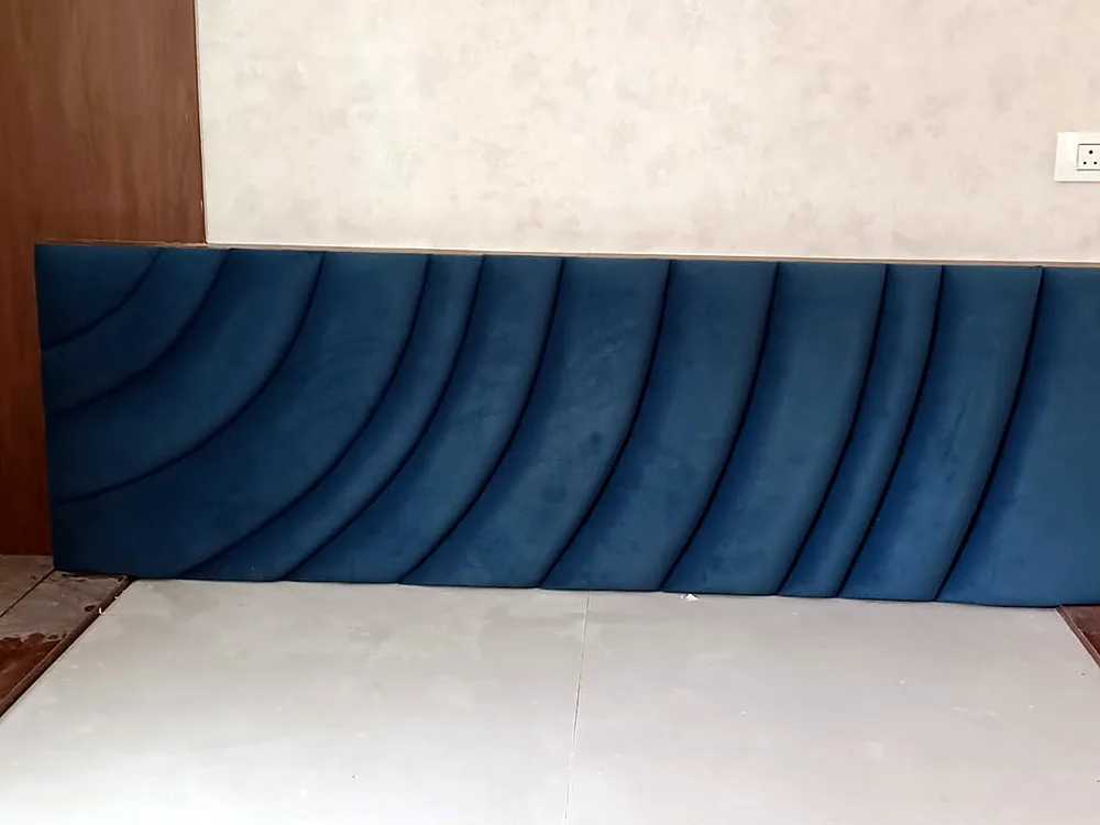 Channel-tufted headboard in deep blue velvet